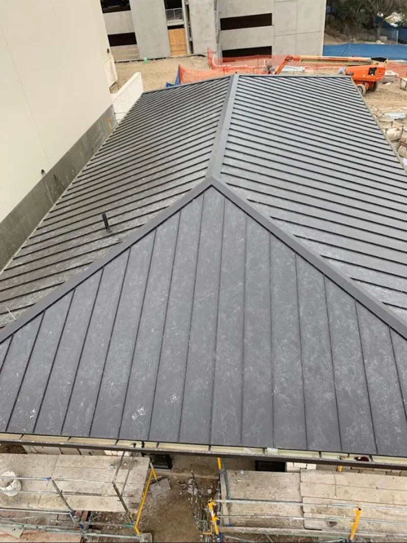 Commercial metal roof construction with crane equipment in Lopatcong